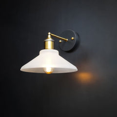 Conical glass wall light with matte sand top cover and black mount on grey wall
