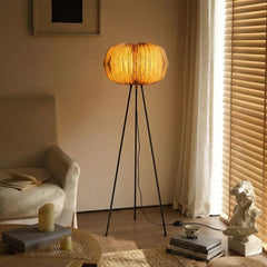 Triangular Ori floor lamp in a living room showing warm ambient glow