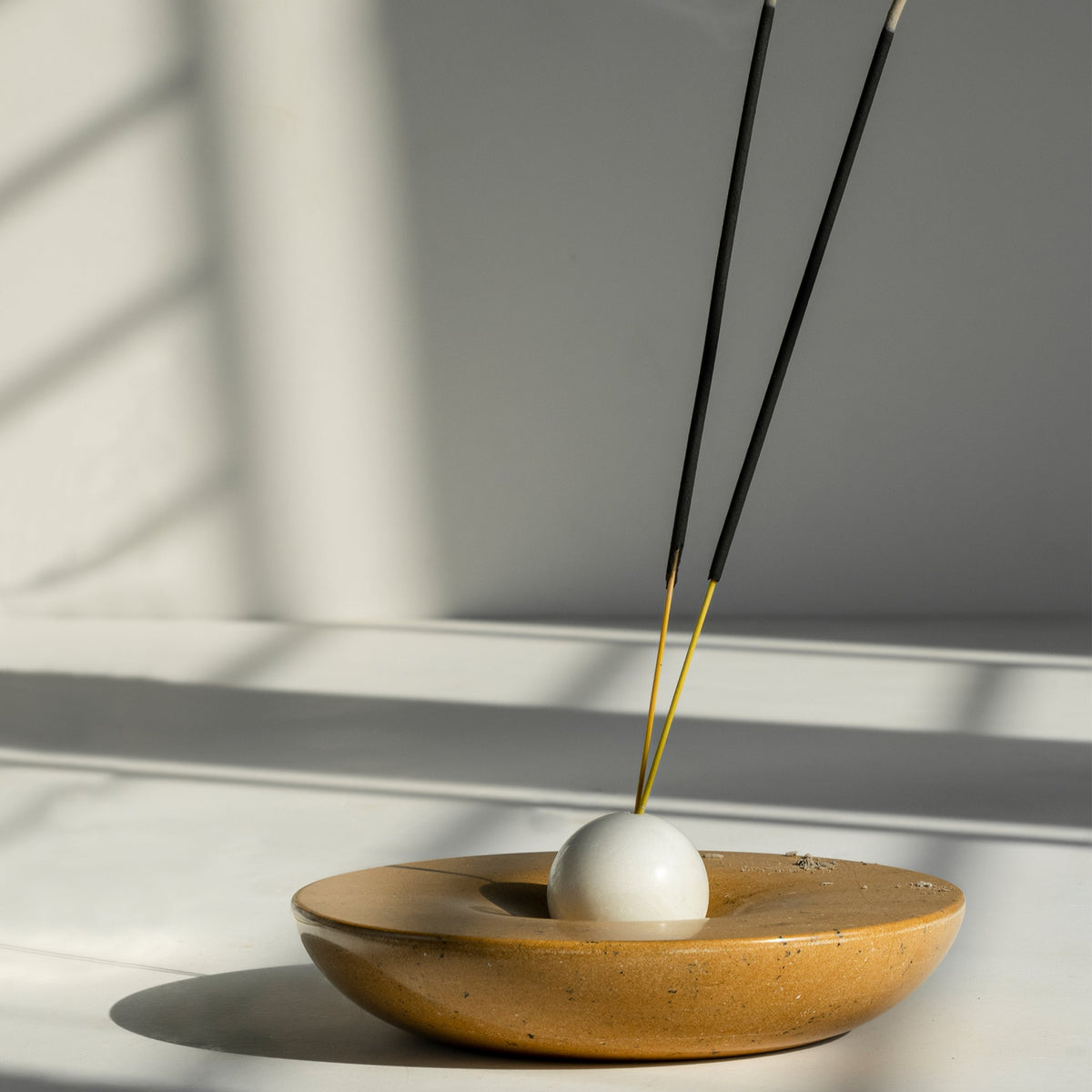 Kaori Incense stick holder with incense sticks on a white surface
