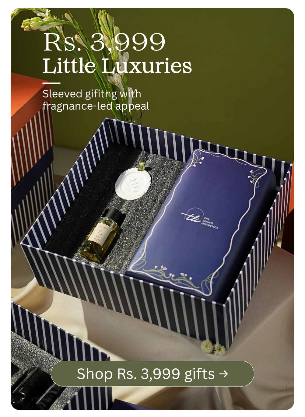 A luxury gift set online at affordable price, under the heading 'Rs. 3,999 Little Luxuries. Image features a navy and white striped box with bottle of room perfume and lamp.