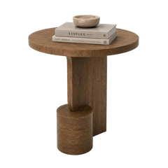 A round wooden side table with a thick cylindrical base, styled with two stacked books and a small stone bowl on top