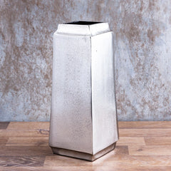 Decorative Hudson vase made of aluminum placed on a wooden table