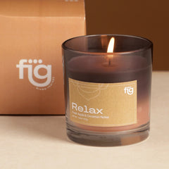 Lit Relax Apple & Cinnamon Vegan Wax Scented Candle by Fig Living against its brand named box