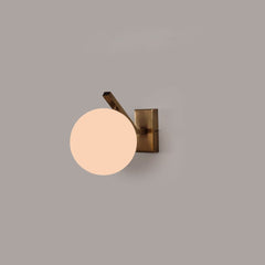 Modern Molt wall sconce glass globe, casting warm light