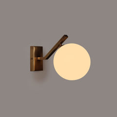 Molt Wall-sconce glass globe light fixture with a round shade on a gray background
