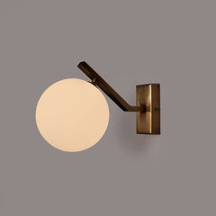 Molt wall sconce light fixture with a round glass shade on a gray background