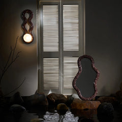 Reva Double Loop Wall sconce, handcrafted in glass mosaic with glowing light mounted on wall placed with mosaic design mirror