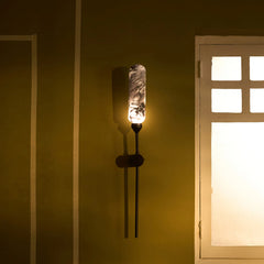 Outdoor Wall Lamp in black and white marble glass & sleek outdoor metal finish. It casts a soft, atmospheric glow elevating exterior spaces 