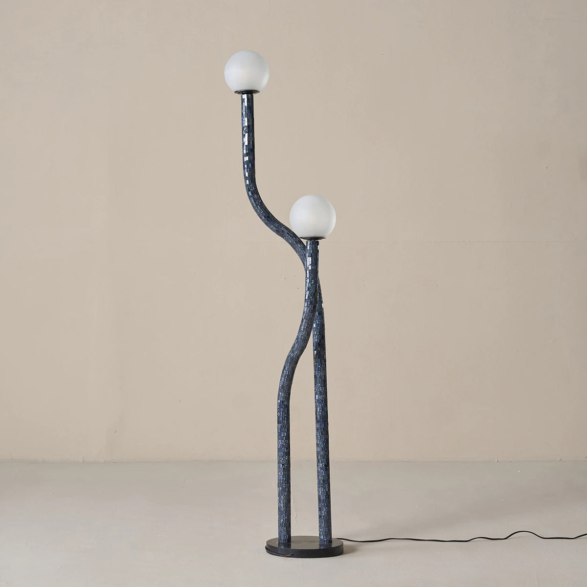 Modern floor lamp with two spherical lights on a plain background