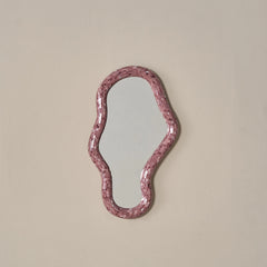 Wavy pink mirror made of glass mosaic