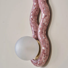 Close view of Reva Triple loop wall sconce made of pink mosaic with white glass globe