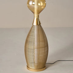 Unique Notto floor lamp with hand woven gold metal wires and glass shade