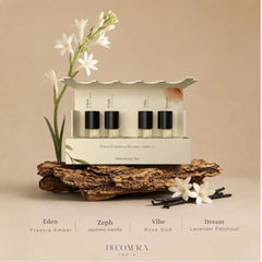 Room Perfume Discovery Set: The Mood - Open Gift Box with Four Vials on Tree Bark with Tuberose & Vanilla Beans, Scent Names Below