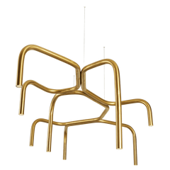 A gold-colored chandelier with a unique branch-like design, consisting of multiple curved rods arranged in a asymmetric pattern, with lighting fixtures at the ends.