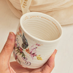 Kulhad Botanical Affaire made of fine bone china with a hand-painted design of a bird and flora, adorned with 24K gold work.
