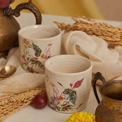 Two Kulhad Botanical cups with hand-painted design of a bird and flora, made of fine bone china adorned with 24K gold work.