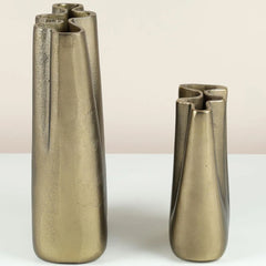 Two metallic peru vases on a white surface with a beige background