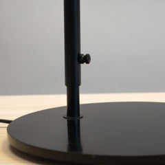 Svelte Scandi Table Lamp, made of black circular mounting base. Close view