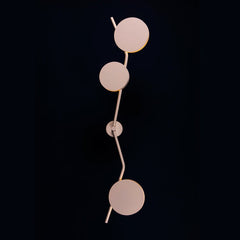 Unique Lino wall sconce with circular design on a black background