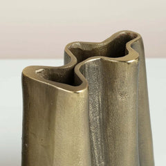 Close look of bronze peru vase with wavy design on a white background