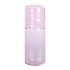 Pink water Juliette glass bottle with a matching cap on a white background
