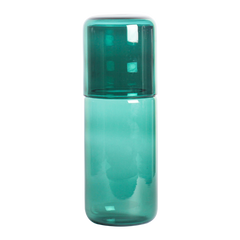 Green Juliette glass bottle with a matching green cap on a white background