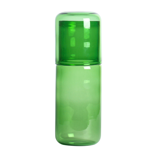 Green Juliette glass bottle with cap on a white background