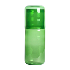 Green Juliette glass bottle with cap on a white background