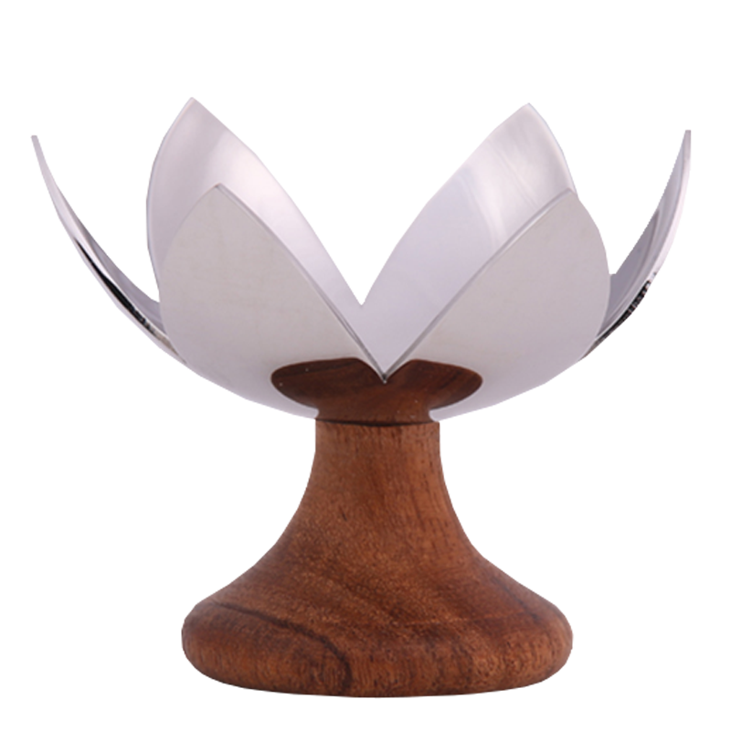 Lotus Blossom - A chrome-finished metal tea light holder with a design resembling a lotus flower, mounted on a wooden base.