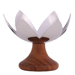 Lotus Blossom - A chrome-finished metal tea light holder with a design resembling a lotus flower, mounted on a wooden base.