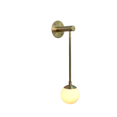 A Dot series wall-mounted sconce with a long glass globe and a brass base and stem.