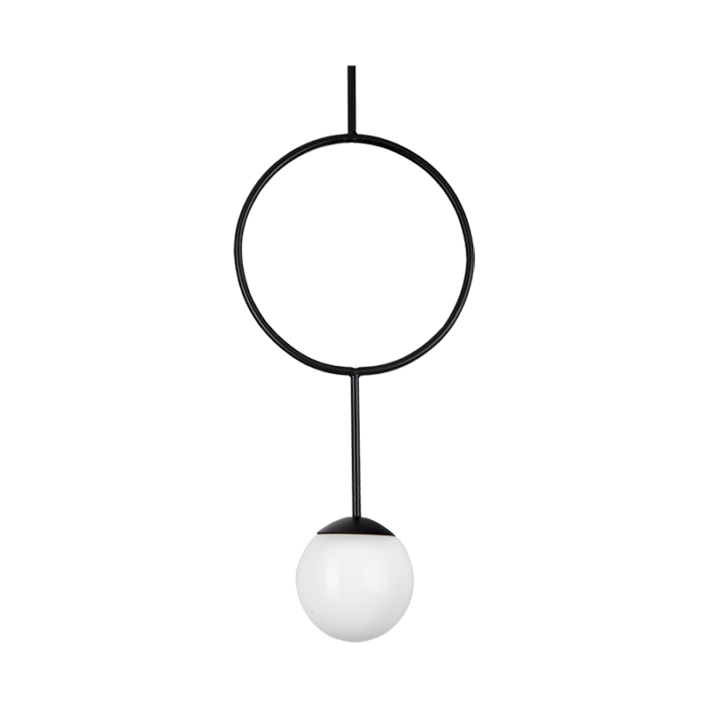 A pendant lamp with a opal glass globe and a black ring with powder-coated aluminium. The lamp is hanging and has a warm white light.