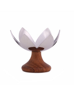 Lotus Blossom chrome-finished metal tea light holder featuring lotus flower design, mounted on a wooden base.