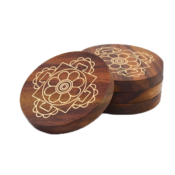 A set of four round Sheesham wood Mandala Coasters with a cosmic mandala pattern engraved on them.