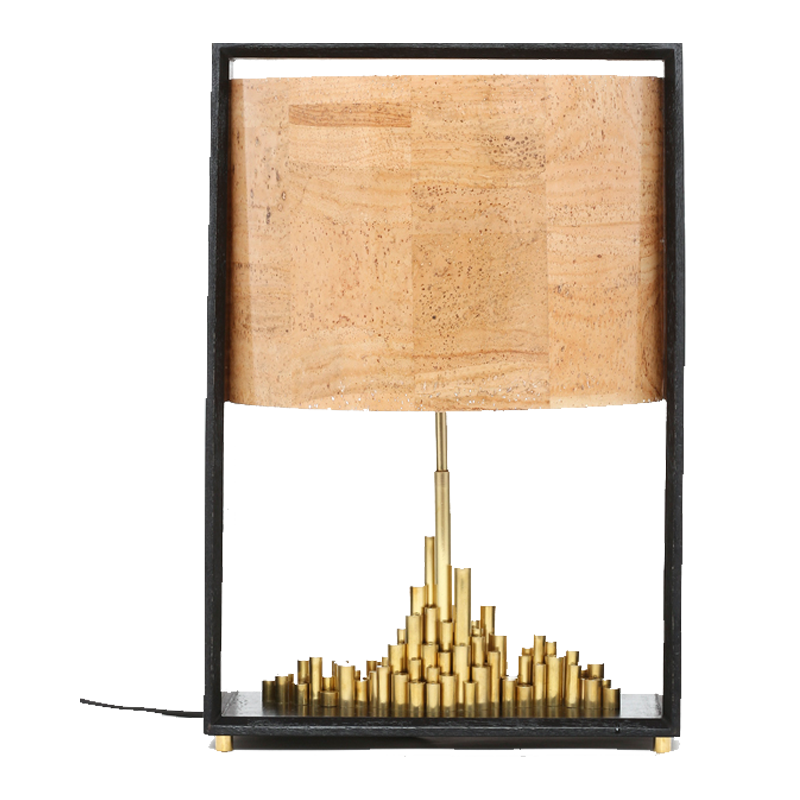 City of Light table lamp with a brass cityscape base and a cork sheet shade, mounted on a dark matte wood finish stand.