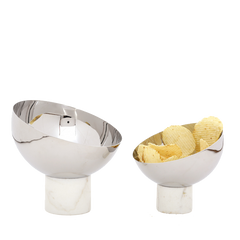 Two modern stainless steel Para Bowls with marble bases, one containing potato chips, on a white background.