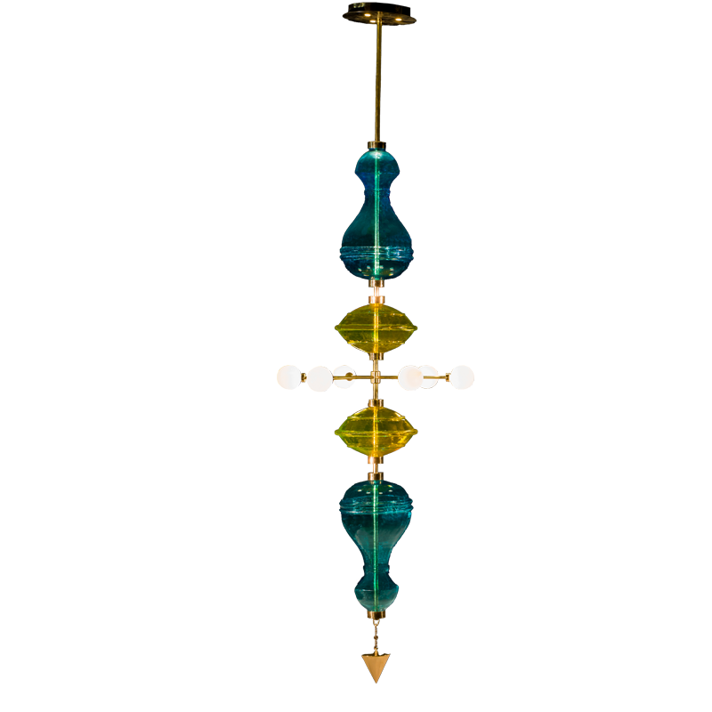 A Shikhara 9' chandelier with blue and yellow glass pieces and brass/copper details, suspended vertically with LED lighting.