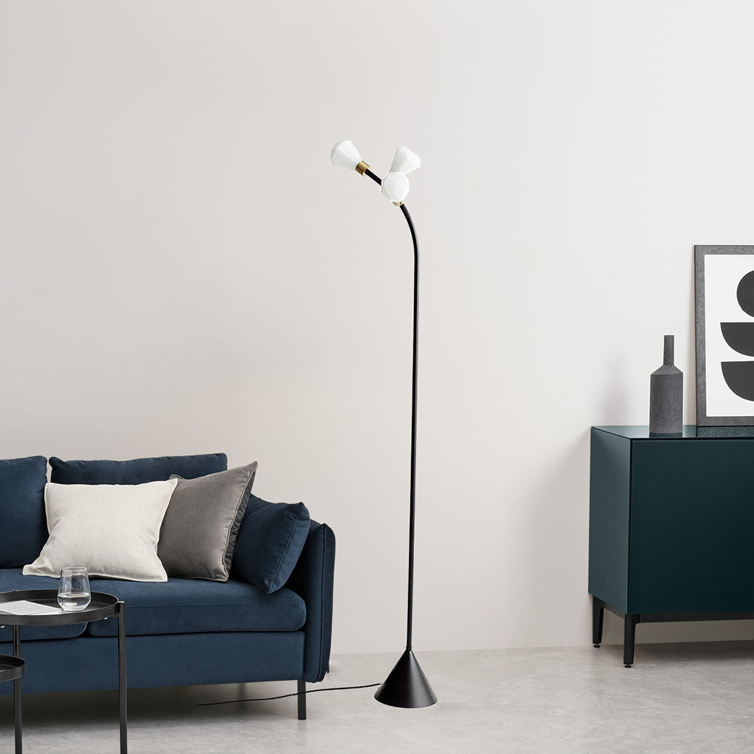 Bloom Floor Lamp with flower-inspired shade illuminated in a living room corner
