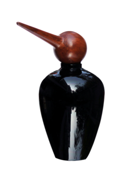 Close view of black glass jar with a bird-shaped top made of wood