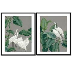 Two framed unique art prints of cranes surrounded by foliage.