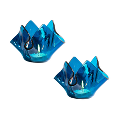 Two blue glass candle holders on a white background