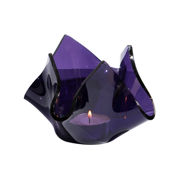 Purple glass candle holder with a lit candle on a white background