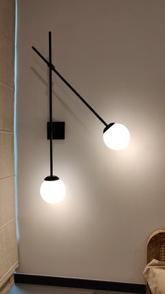 Modern wall sconce with frosted glass shade casting warm ambient glow on white wall video