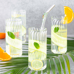 Tall clear firdaus cocktail glasses with a ribbed/fluted design, stem-less. 4 textured design glasses one with glass of straw. 