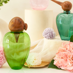 Chirp Parrot Glass Jar placed on table with chirp penguin glass bottle in background