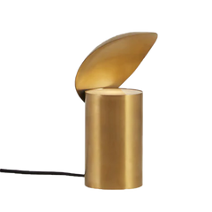 A gold colored table lamp with a shell-like design, where the lampshade is attached to the top of the cylindrical base.