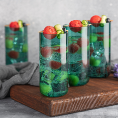 Juliette Straight Cocktail Glasses in teal color by glass forest placed on a wooden tray