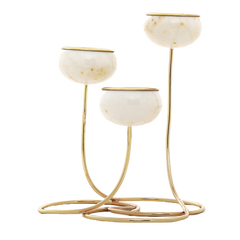 Trilight - Three-tier gold metal candle holder with round white marble candle cups, set against a solid white background.