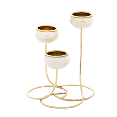 A three-tier gold and white marble candle holder with a polished gold metal base and rims, set against a solid white background.