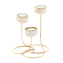Three gold metal candle holders with round white stone or marble cups, each holding a white tea light candle, shown on a plain white background.